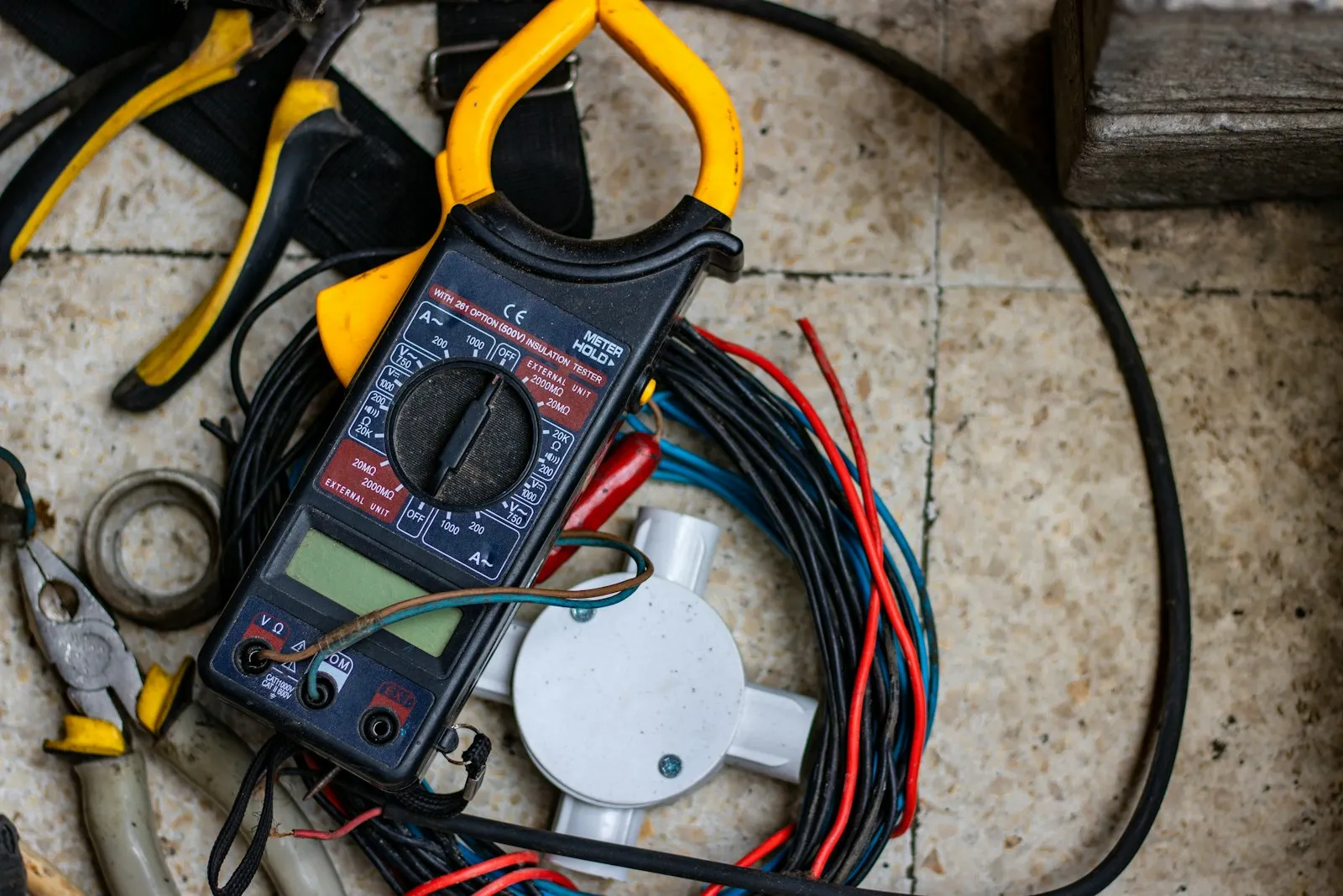 Black and yellow clamp meter with test leads